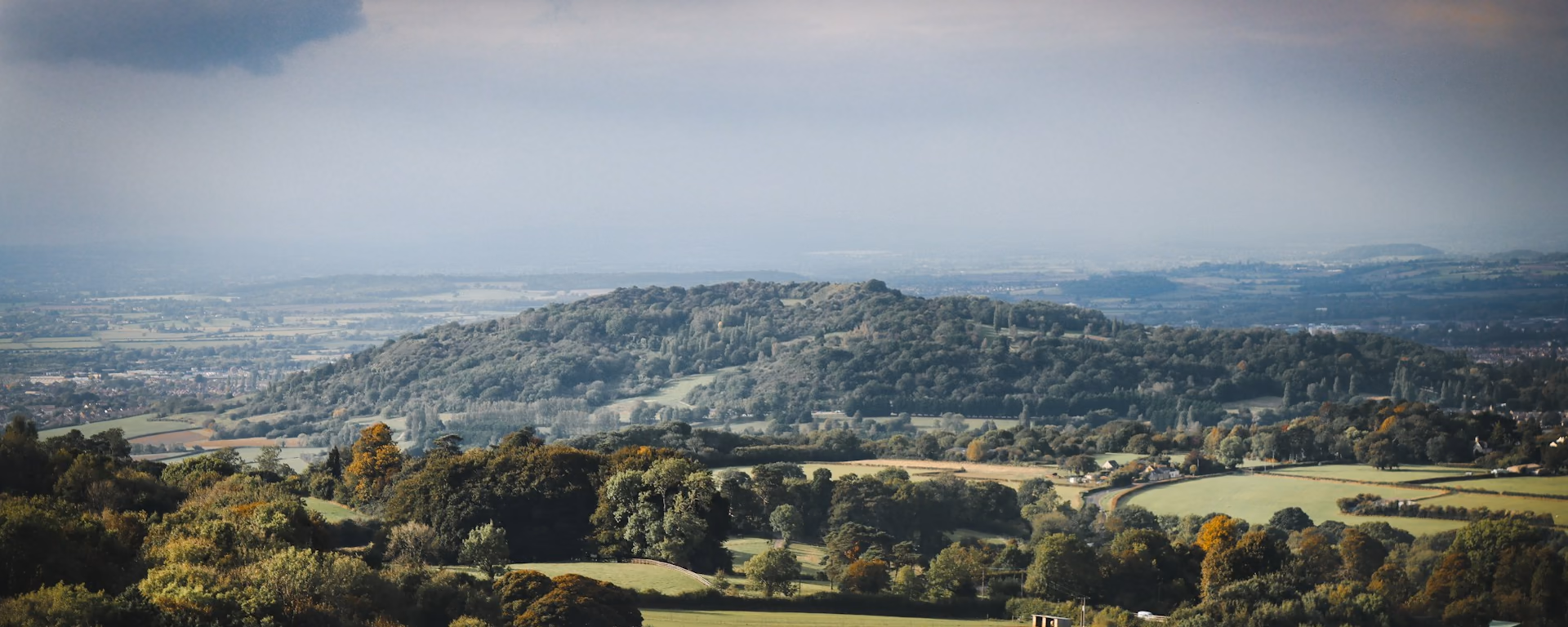 Wooded valley and rolling hills seen from a high path
